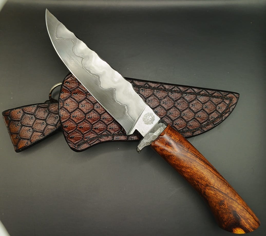 Fixed blade Hunters knife with a broad blade, Solid Wood handle and metal Hand guard.